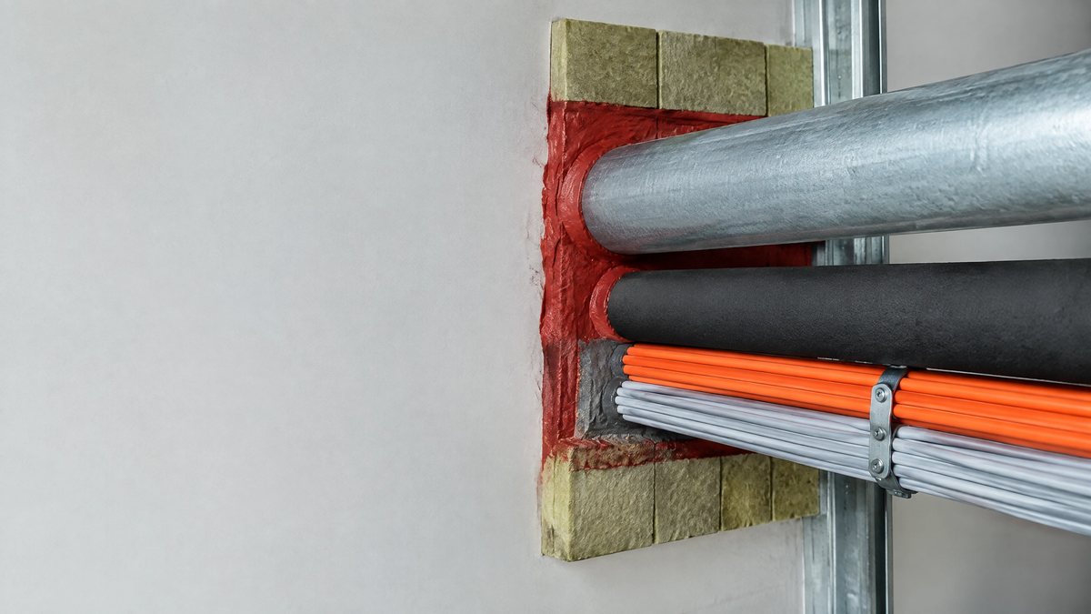 Fire stopping detail where services pass through a compartment wall
